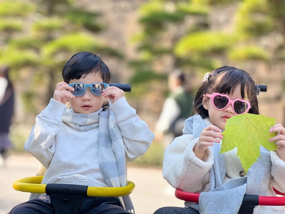 Người đẹp check-in tại công viên Disneyland ở Tokyo. Hai nhóc tì dễ thương được bố mẹ trang bị cho quần áo ấm và khăn quàng cổ.