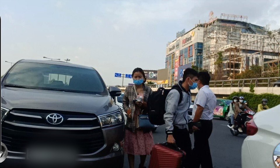 Nhiều hành khách chấp nhận cuốc bộ hàng trăm mét từ trong sân bay ra đến đường Trường Sơn để bắt xe.
