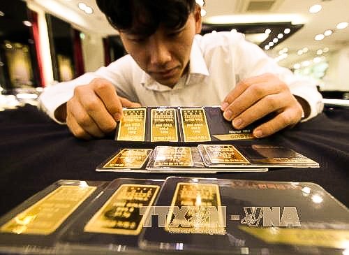 Các nhà phân tích cho rằng, vàng trong tuần tới vẫn không thể bứt phá và tiếp tục neo quanh mức 1.800 USD/ ounce. Ảnh: TTXVN