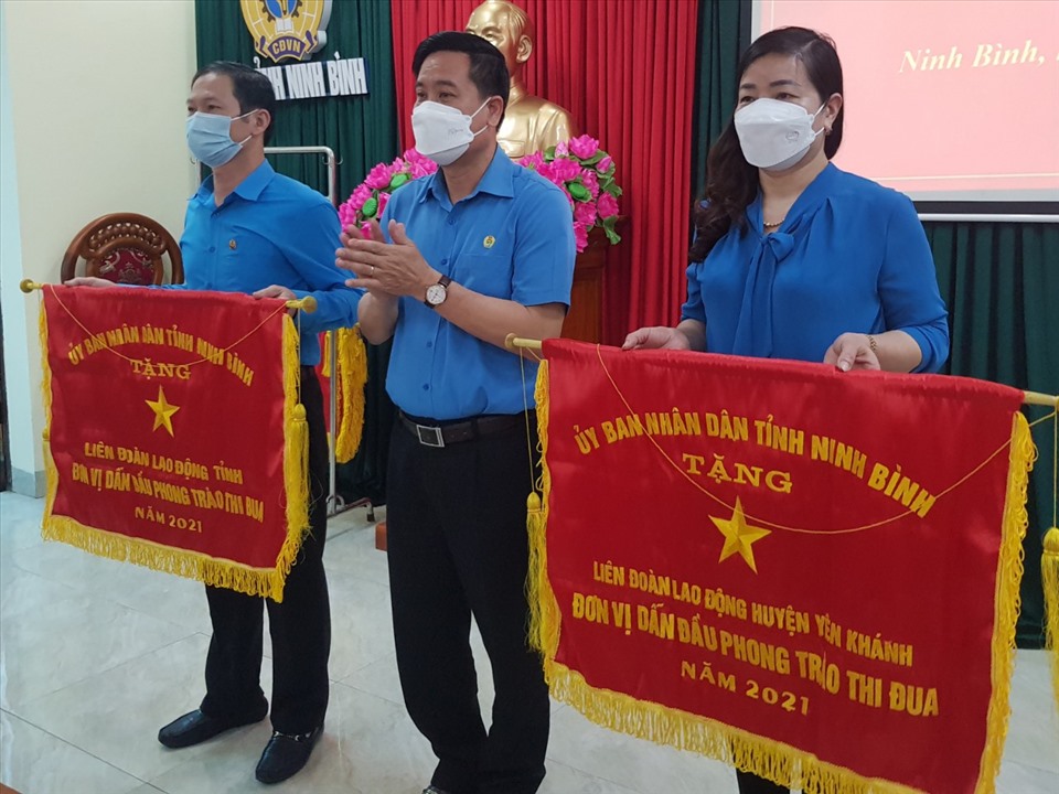 Lãnh đạo LĐLĐ tỉnh Ninh Bình trao Cờ thi đua của UBND tỉnh cho các tập thể có thành tích xuất sắc trong các phong trào thi đua năm 2021. Ảnh: NT