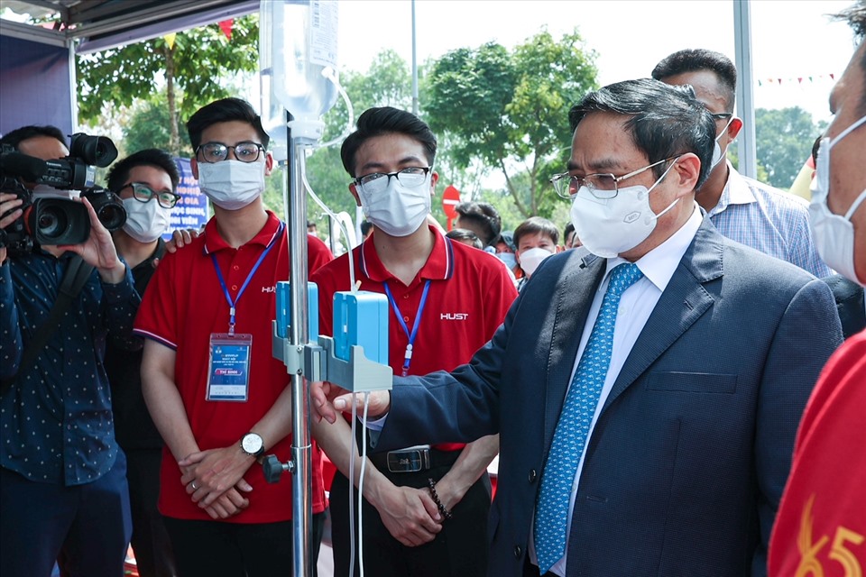 Thủ tướng thăm gian hàng của Trường Đại học Bách khoa Hà Nội trưng bày các sản phẩm ứng dụng trí tuệ nhân tạo, hỗ trợ, quản lý điều trị người mắc COVID-19. Ảnh: Nhật Bắc