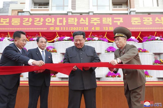 Kim Jong-un cuts the ribbon to inaugurate a residential area in Pyongyang on April 13.  Screenshots