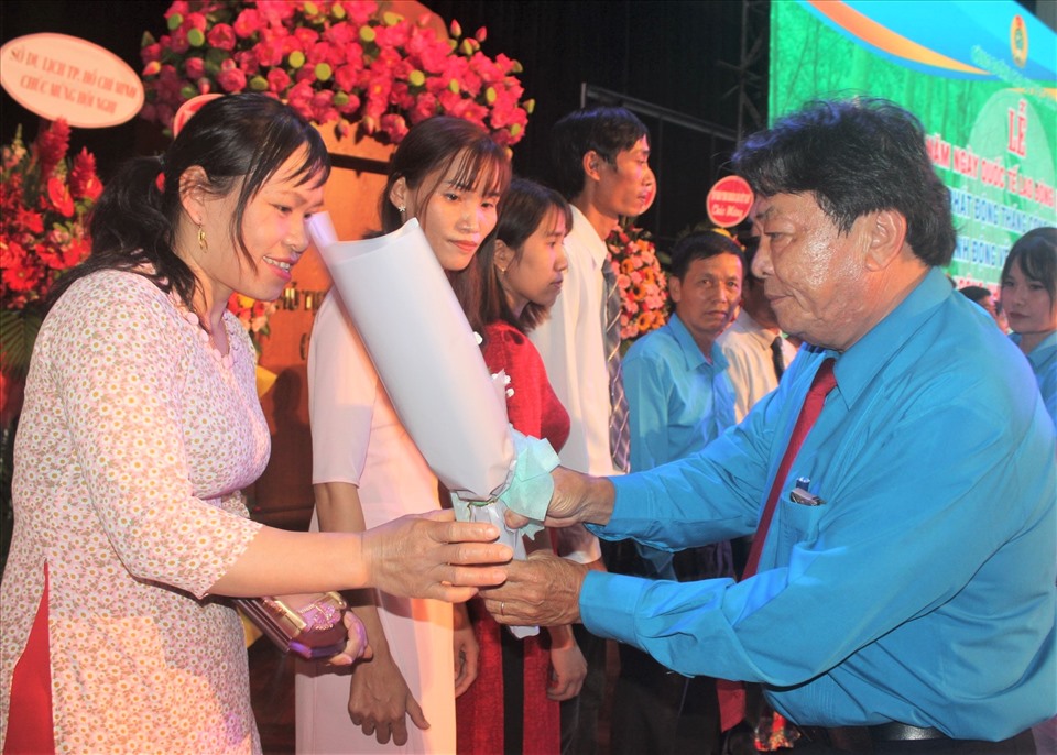 Chủ tịch Công đoàn Cao su Việt Nam Phan Mạnh Hùng  tặng hoa và biểu trưng cho Công nhân cao su Việt Nam ưu tú. Ảnh: Đức Long