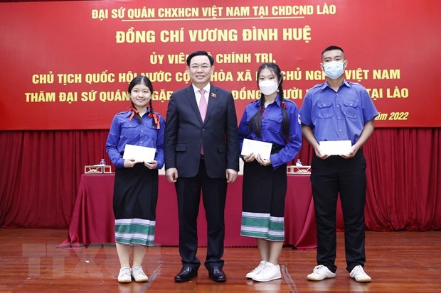 Chủ tịch Quốc hội Vương Đình Huệ tặng quà học sinh trong cộng đồng người Việt Nam tại Lào. Ảnh: TTXVN