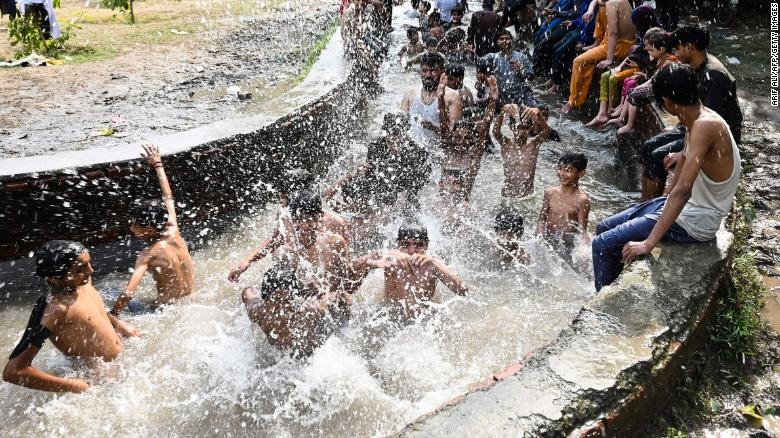 Pakistanis find a way to cool off, April 29, 2022.  Photo: AFP