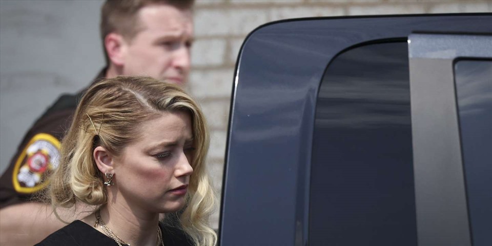 Amber Heard bị phóng viên vây quanh và đặt câu hỏi nhưng không trả lời. Ảnh: AFP.