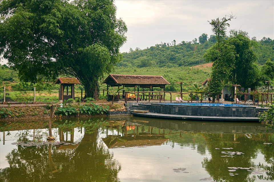 Ao thả cá Koi. Phía xa xa là hình ảnh lũy tre bên mái ngói, một hình ảnh quen thuộc của bất kỳ làng quê Việt Nam nào.