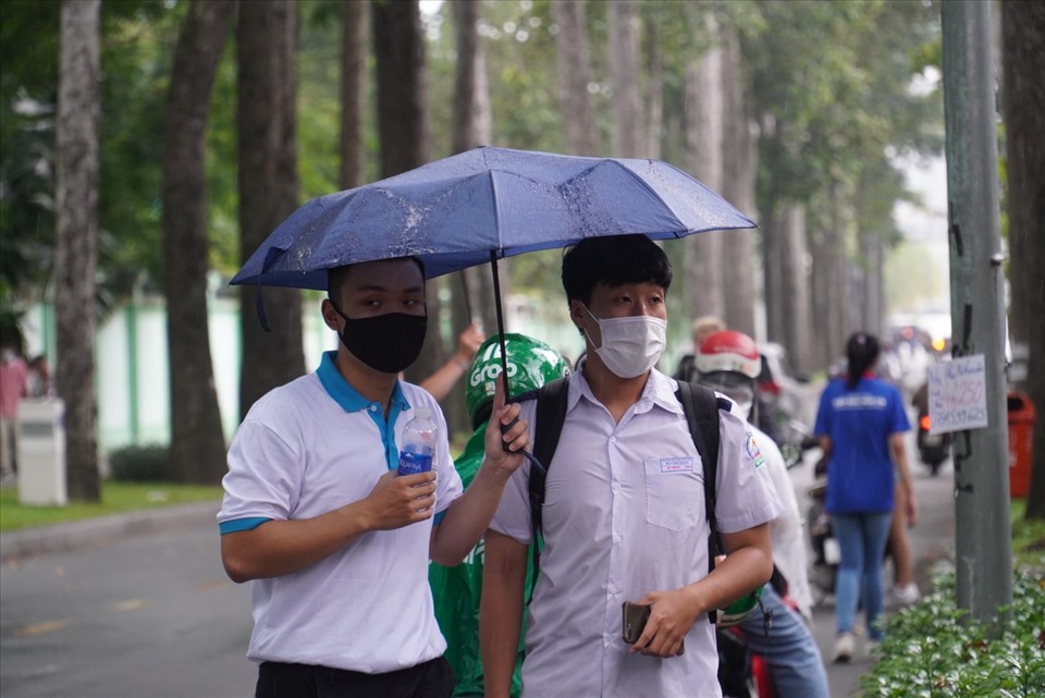 Ghi nhận của PV tại trường THPT Trưng Vương, chiều nay trời có mưa, cơn mưa ngày càng nặng hạt khiến các thí sinh gặp đôi chút khó khăn trong buổi làm thủ tục dự thi tốt nghiệp THPT 2022.