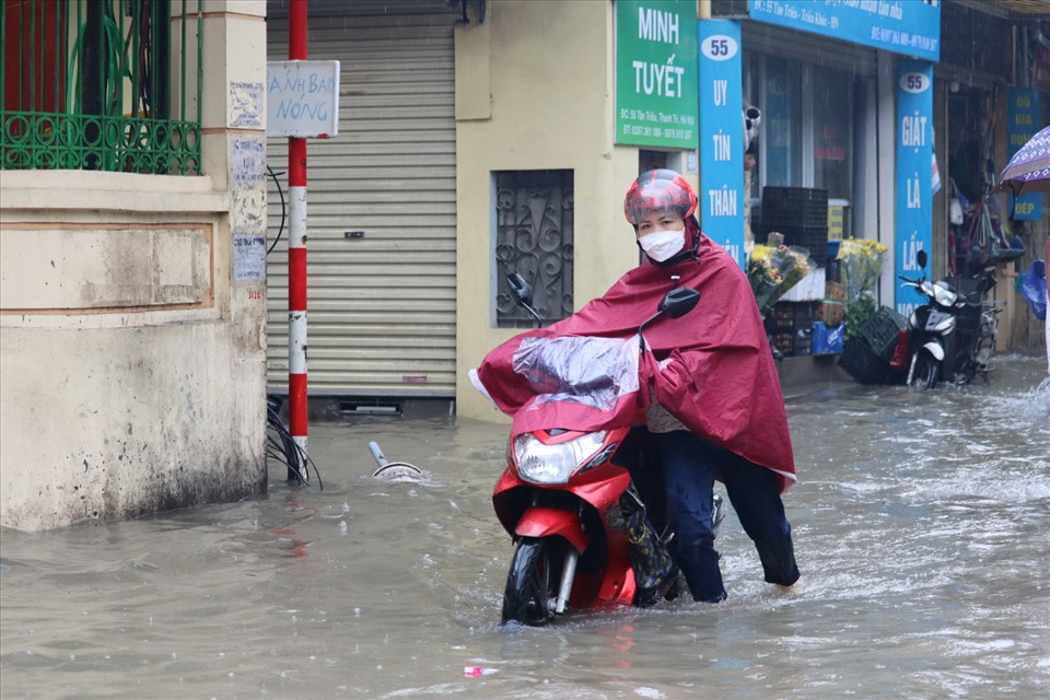 Ghi nhận tại đường Tân Triều, Thanh Trì, Hà Nội lúc 12h, nước ngập sâu khoảng 50cm. Nước ngập sâu khiến việc di chuyển của người dân gặp khó khăn, nhiều xe chết máy