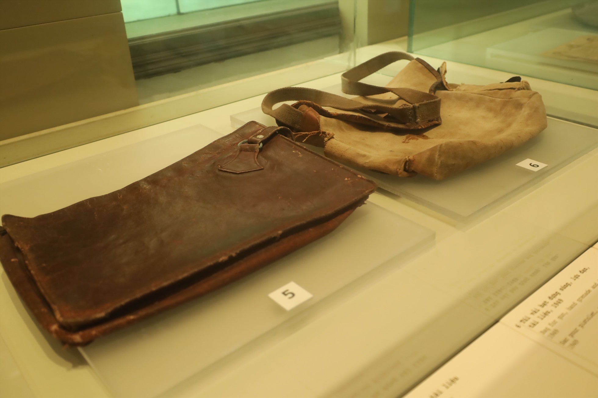 Cặp da đựng tài liệu, túi vải bạt đựng súng, lựu đạn những năm 50 thế kỷ trước. Ảnh: Nguyễn Thuý