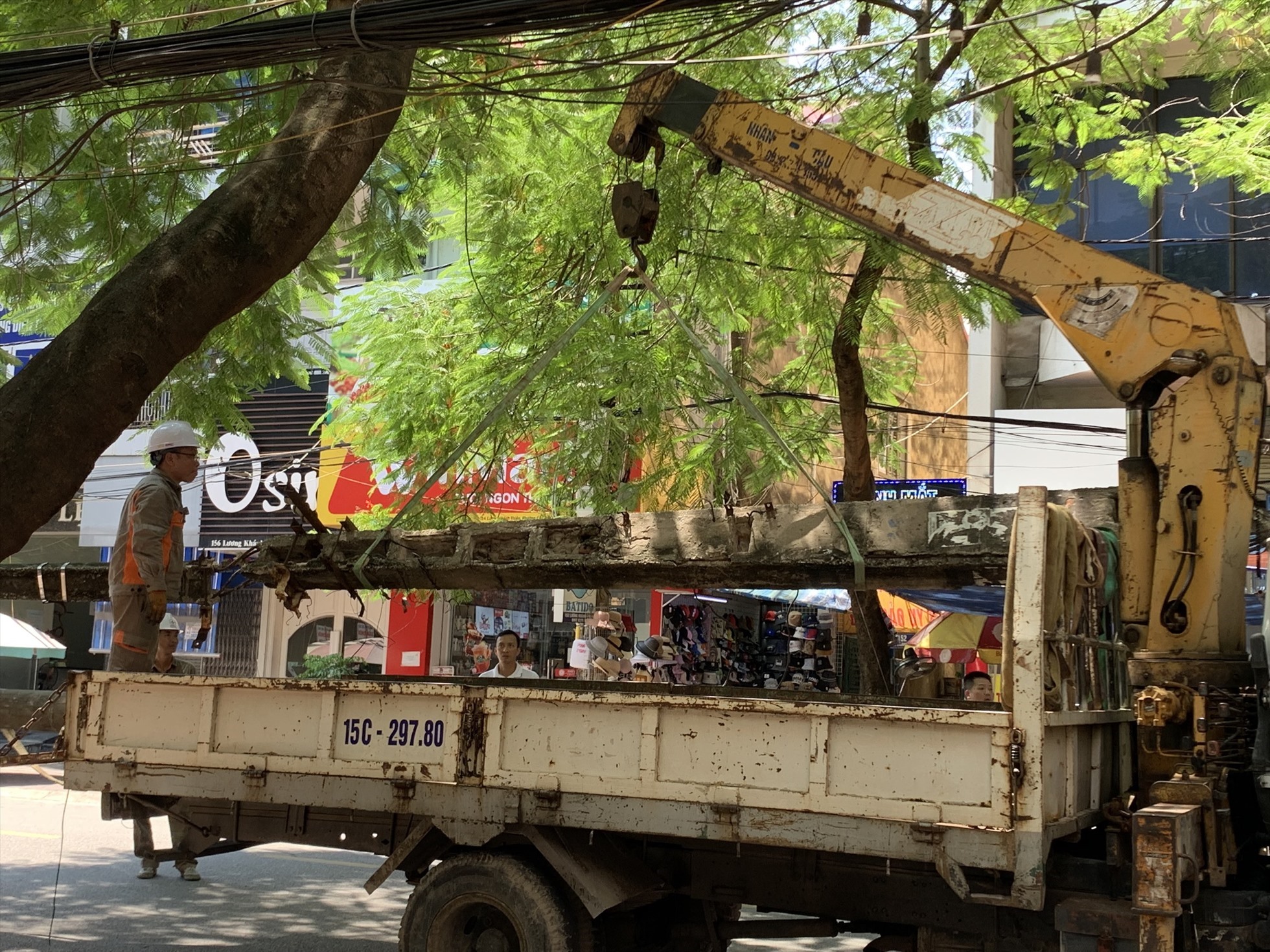 Đội cứu hộ xử lý cột điện bị đổ. Ảnh: Lương Hà 