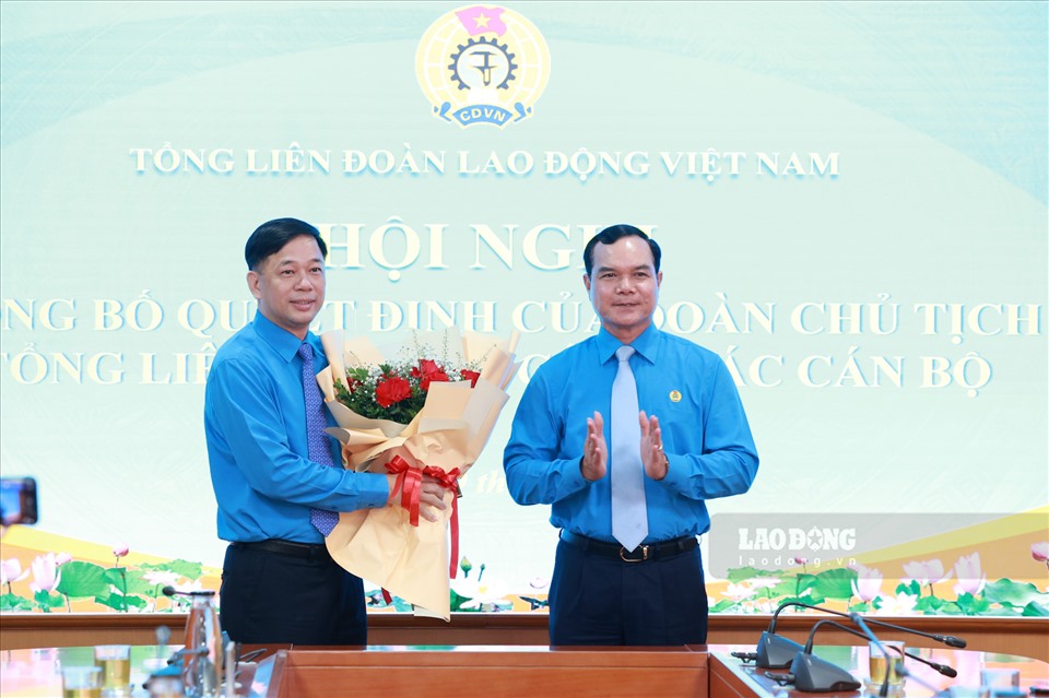 Đồng chí Nguyễn Đình Khang - Uỷ viên Trung ương Đảng, Chủ tịch Tổng LĐLĐVN trao quyết định và tặng hoa cho đồng chí Tống Văn Băng (bên trái). Ảnh: Hải Nguyễn