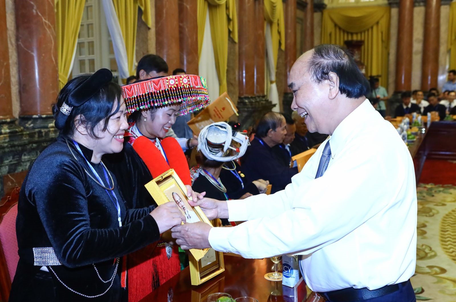 Chủ tịch nước Nguyễn Xuân Phúc tặng tranh chân dung Chủ tịch Hồ Chí Minh cho các đại biểu tại buổi gặp. Ảnh: VPCTN