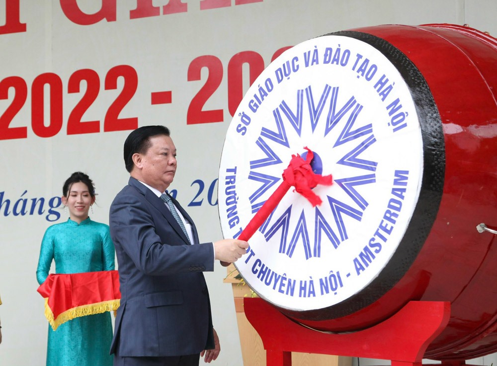 Bí thư Thành ủy Hà Nội Đinh Tiến Dũng tặng lẵng hoa chúc mừng năm học mới 2022-2023 tới thầy và trò nhà trường. Ảnh: Viết Thành