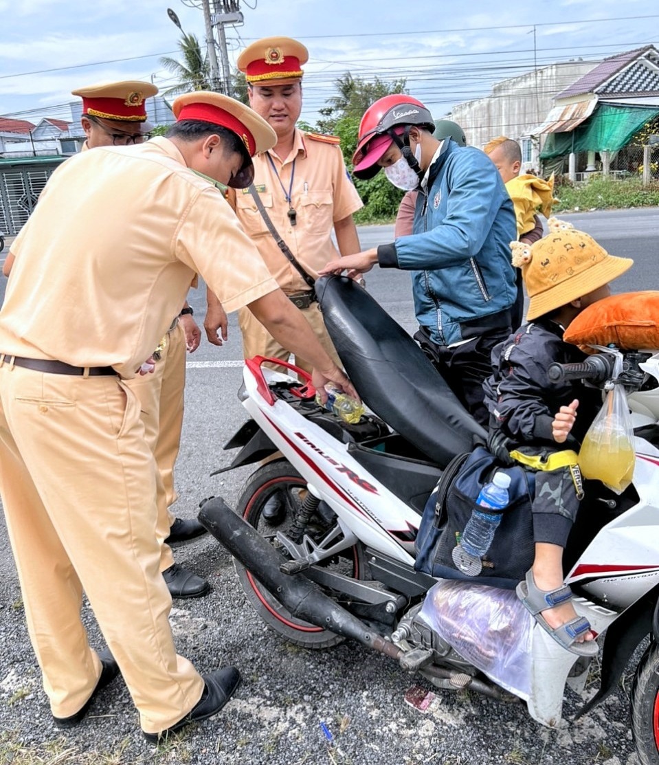 Cảnh sát Giao thông tỉnh Bạc Liêu tặng xăng cho người dân di chuyển đến nhà máy xí nghiệp sau thời gian nghỉ Tết 2023. Ảnh: Nhật Hồ