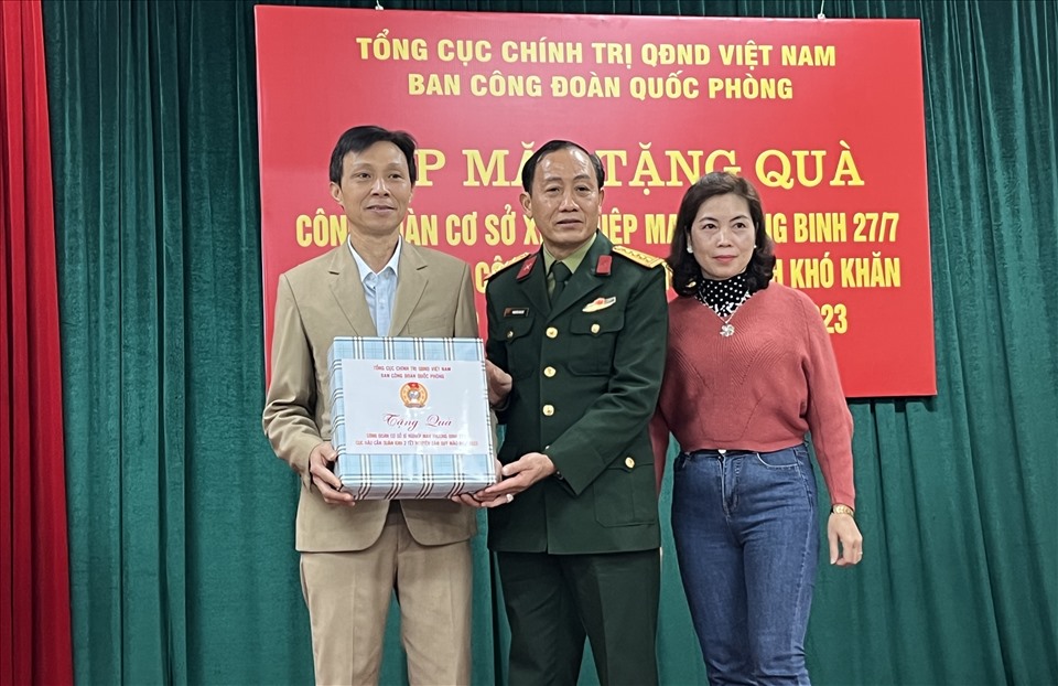 Đại tá Nguyễn Văn Đề (giữa), Phó Trưởng ban Công đoàn Quốc phòng trao quà hỗ trợ Tết cho Công đoàn cơ sở Xí nghiệp May thương binh 27-7 . Ảnh: Linh Nguyên