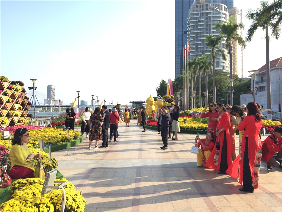 Du khách chọn áo dài để chụp hình tại đường hoa xuân Đà Nẵng.