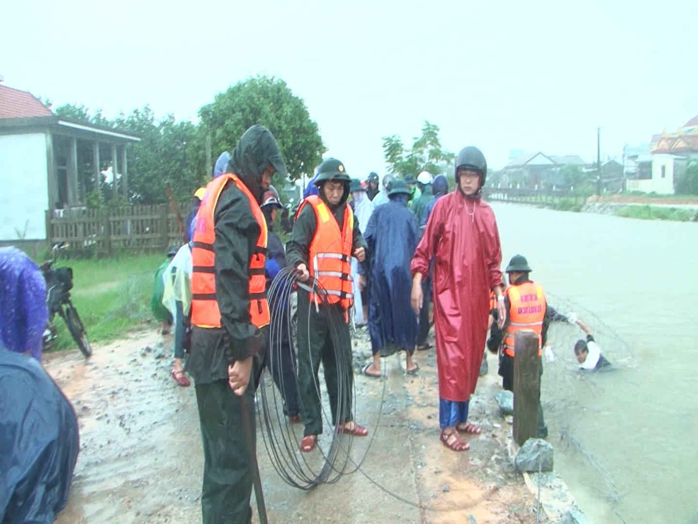 Lực lượng vũ trang Thừa Thiên Huế dầm mưa chống sạt lở đê do mưa lớn. Ảnh: Lê Sáu