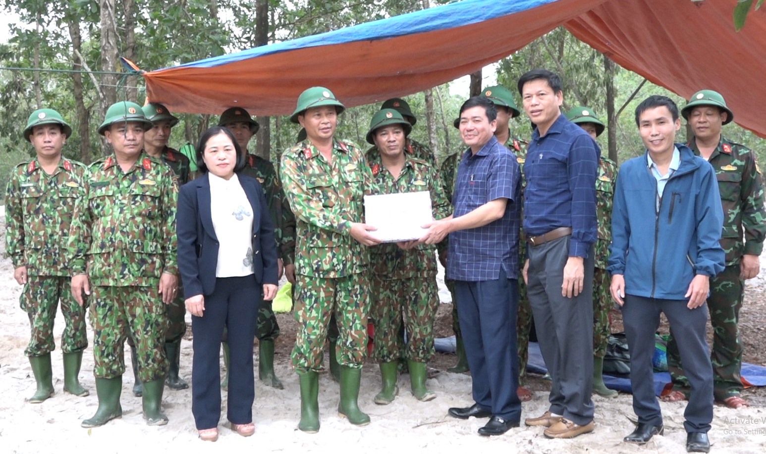 Lãnh đạo UBND huyện Triệu Phong tặng quà động viên cho Đội 584 đang tìm kiếm hài cốt liệt sĩ. Ảnh: T.Phong.