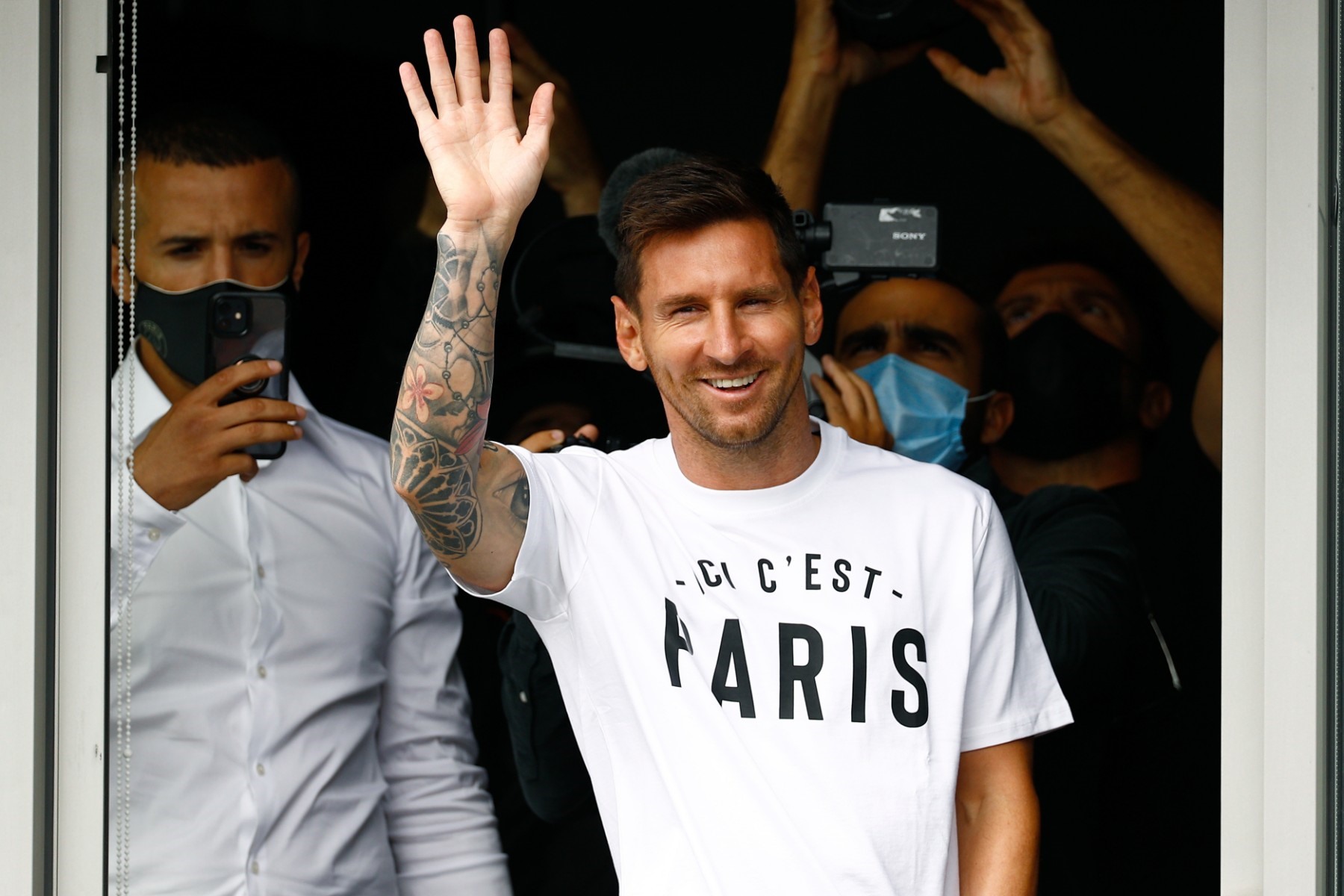 Cầu thủ bóng đá người Argentina Lionel Messi vẫy tay chào người hâm mộ tại sân bay Le Bourget, phía bắc Paris ngày 10.8 khi đến ký hợp đồng gia nhập câu lạc bộ Paris Saint-Germain. Cầu thủ 34 tuổi đã rời Barcelona, câu lạc bộ gắn bó trong suốt sự nghiệp thi đấu chuyên nghiệp kéo dài 17 năm qua. Ảnh: AFP