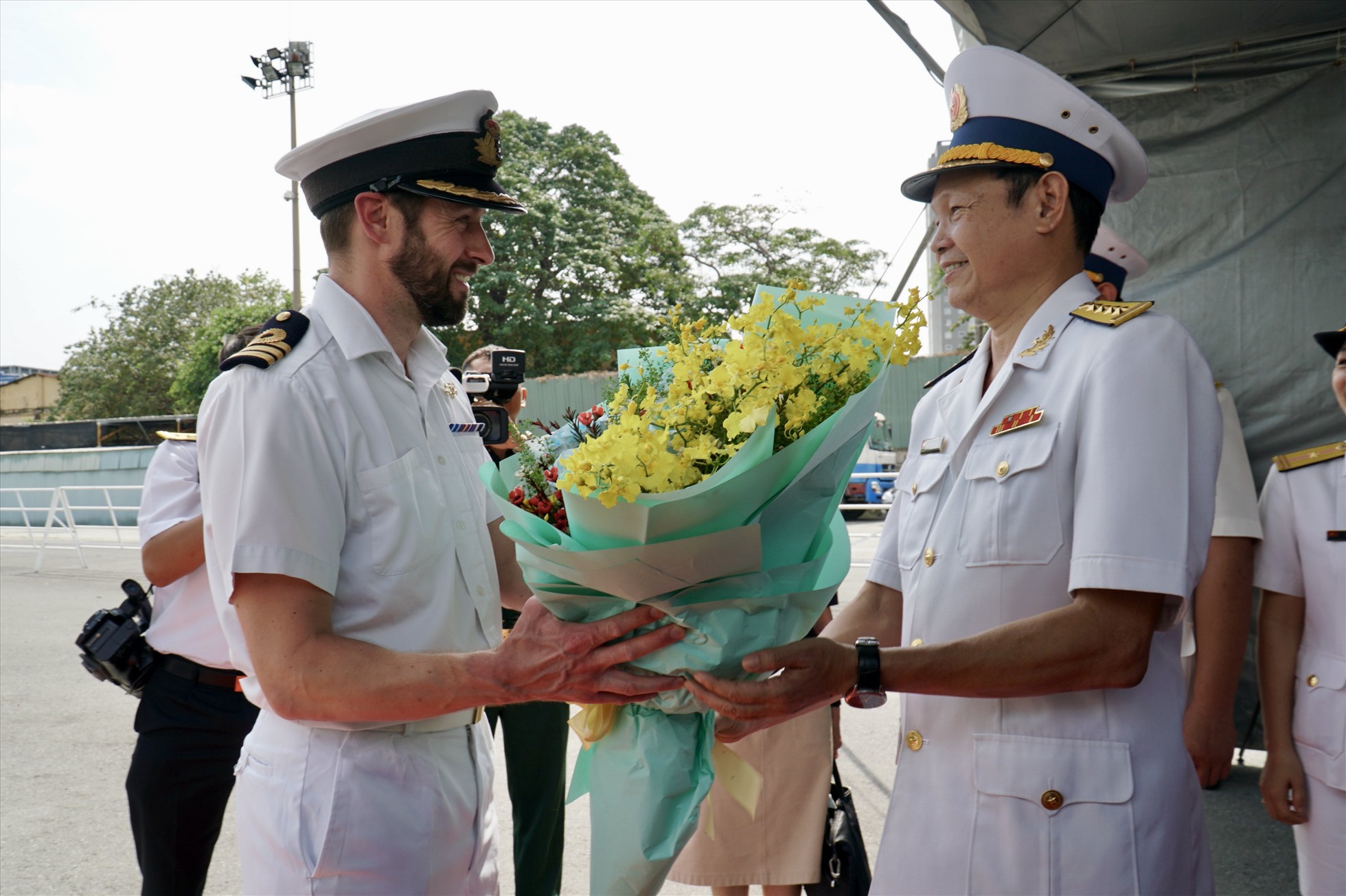 Đại tá Lê Nam Sơn (phải), Phó Lữ đoàn trưởng Lữ đoàn 125, Bộ Tư lệnh Vùng 2 Hải quân đại diện lãnh đạo Quân chủng Hải quân Việt Nam tặng hoa, đón Trung tá Michael Proudman (phải), thuyền trưởng chỉ huy tàu HMS Spey.
