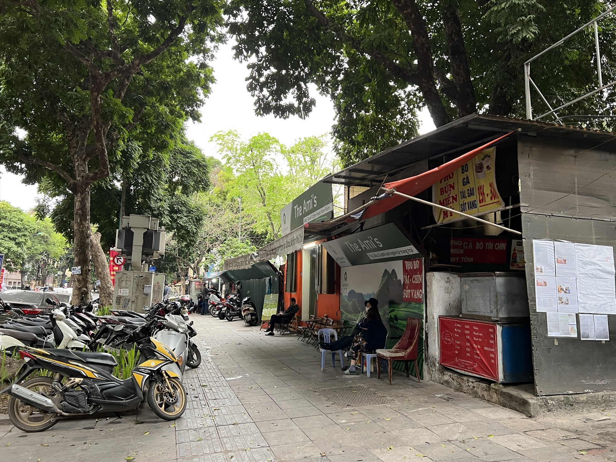 Nhiều người dân tận dụng việc bỏ không đã căng mái tạm che nắng mưa để bán hàng. Ảnh: Nguyễn Thúy.