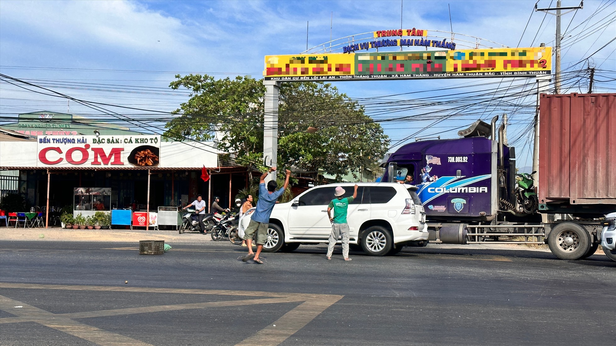 Người dân nâng dây cáp để các xe lưu thông. Ảnh: Duy Tuấn