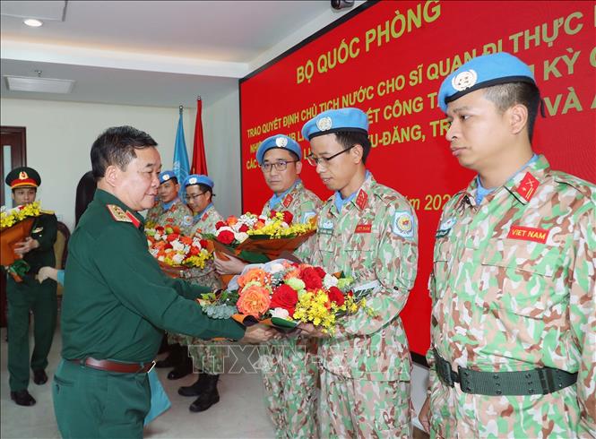 Thượng tướng Hoàng Xuân Chiến, Thứ trưởng Bộ Quốc phòng tặng hoa chúc mừng các sĩ quan vừa hoàn thành nhiệm vụ trở về. Ảnh: Trọng Đức/TTXVN