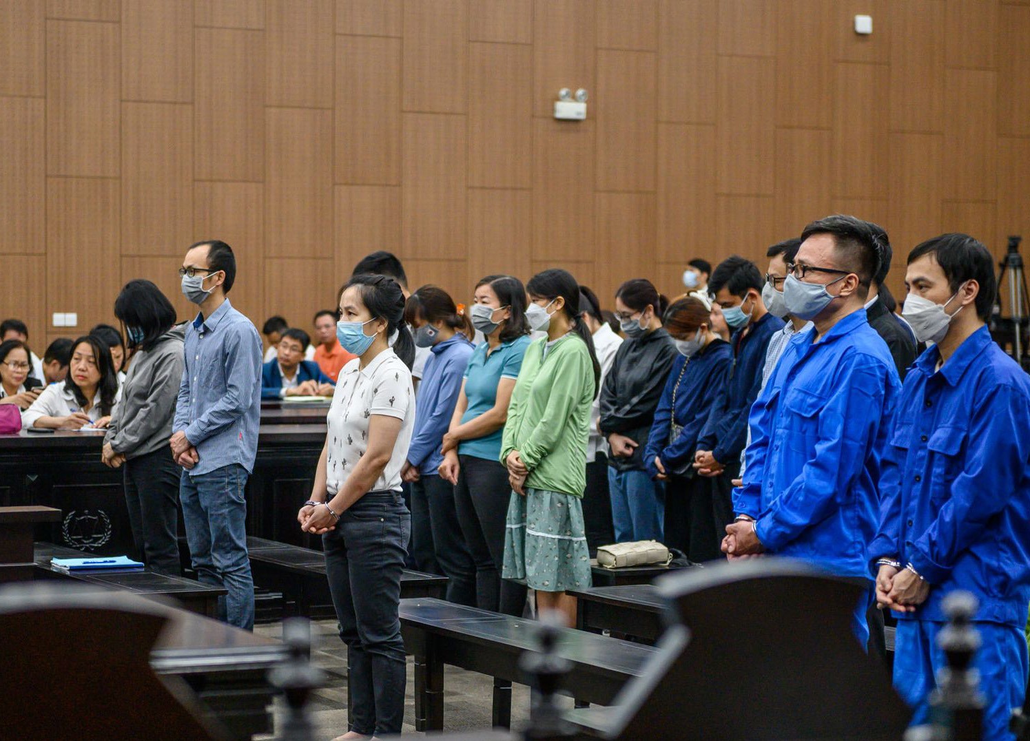 Nguyễn Thị Hà Thành (áo trắng, đứng đầu) cùng các bị cáo nghe toà tuyên án. Ảnh: Việt Dũng