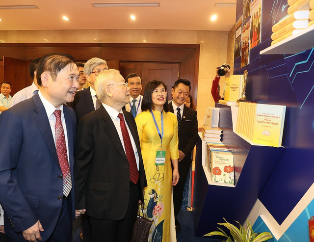 Tổng Bí thư Nguyễn Phú Trọng tham quan gian trưng bày sách tại lễ kỷ niệm. Ảnh: Trí Dũng /TTXVN