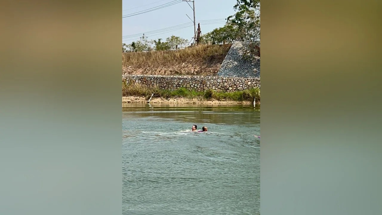 Mike cố bơi vào bờ sau khi rơi xuống hồ vì dây bungee bị đứt. Ảnh: Courtesy Mike