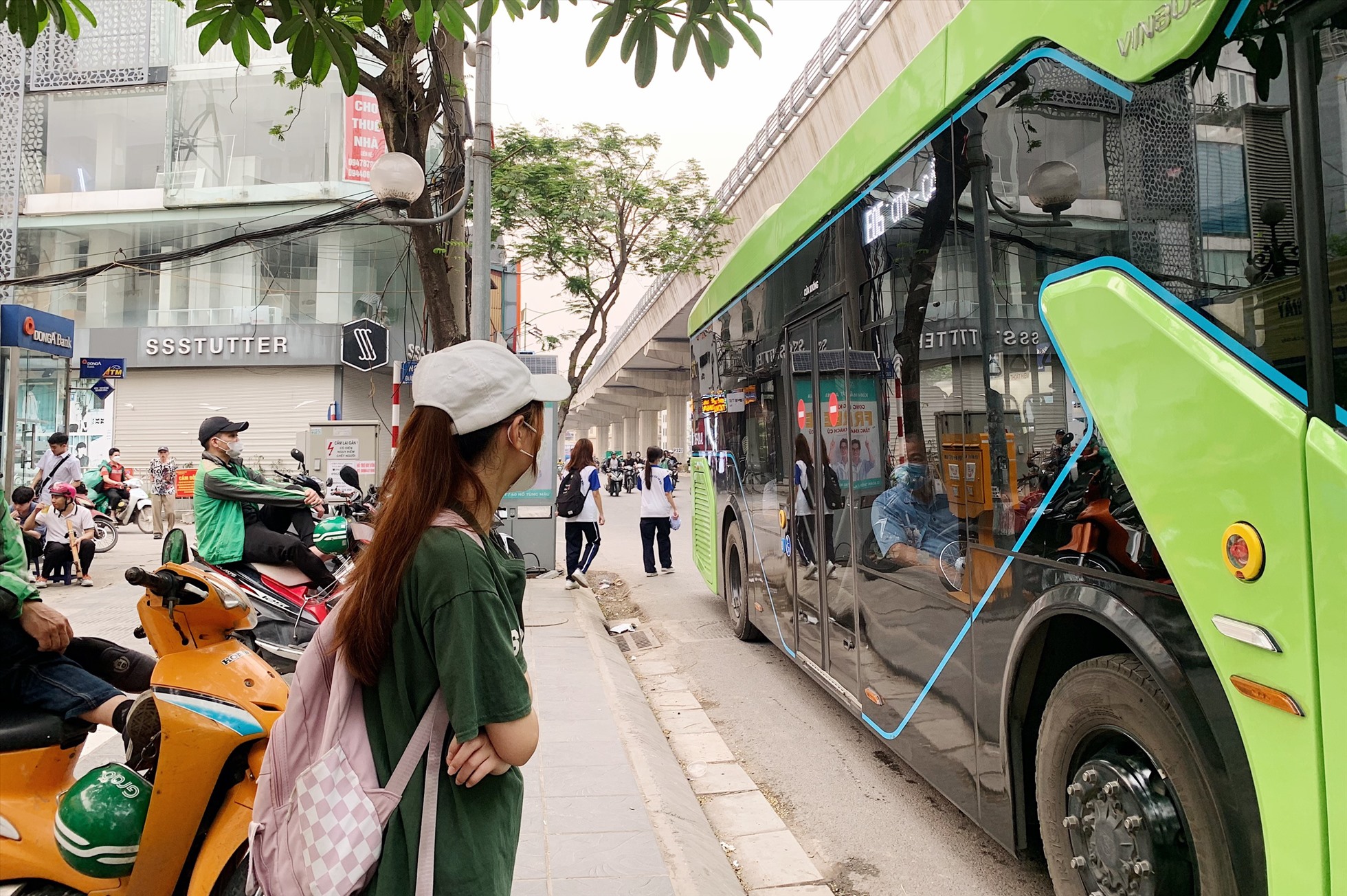 Chị Nguyễn Thị Hồng Nhung đứng đợi tuyến buýt 49 tại đường Cầu Giấy. Ảnh: Thu Hiền