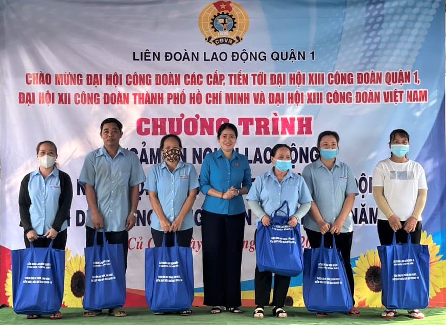 Bà Trương Thị Minh Dung (giữa) - Chủ tịch LĐLĐ Quận 1 - trao quà cho các CNLD( có hoàn cảnh khó khăn. Ảnh: Đức Long