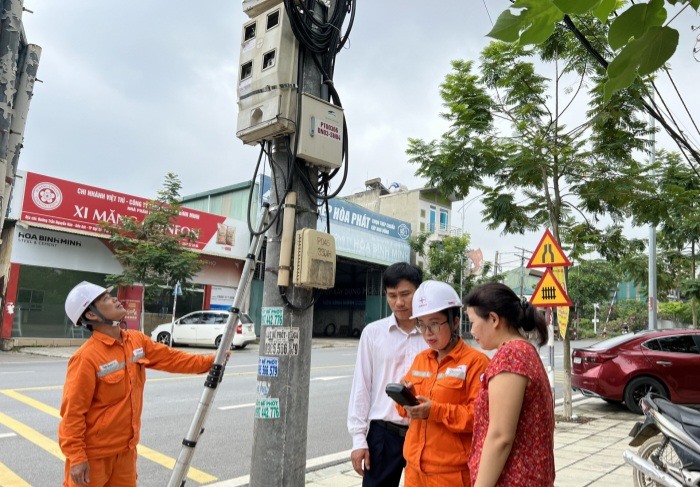 Cán bộ kỹ thuật Điện lực Việt Trì sử dụng thiết bị điện tử đo kiểm tra chỉ số công tơ khi nhận được ý kiến của khách hàng