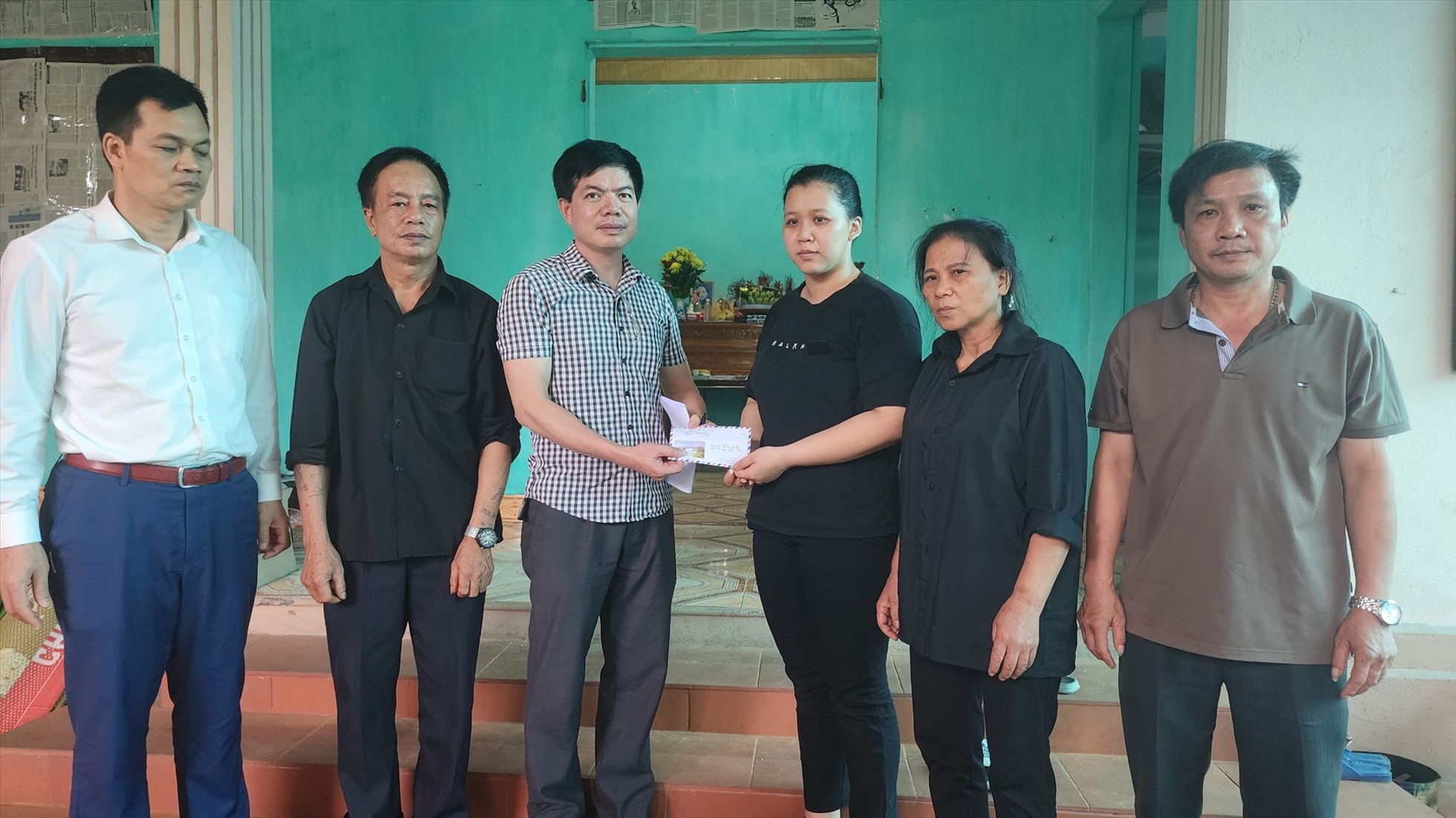 Trước sự chứng kiến của đại diện Công ty CP Than Vàng Danh, đại diện Quỹ TLV Lao Động đã trao tiền hỗ trợ cho gia đình thợ mỏ Lương Hoài Nam tại phường Vàng Danh, TP Uông Bí. Ảnh: T.N.D