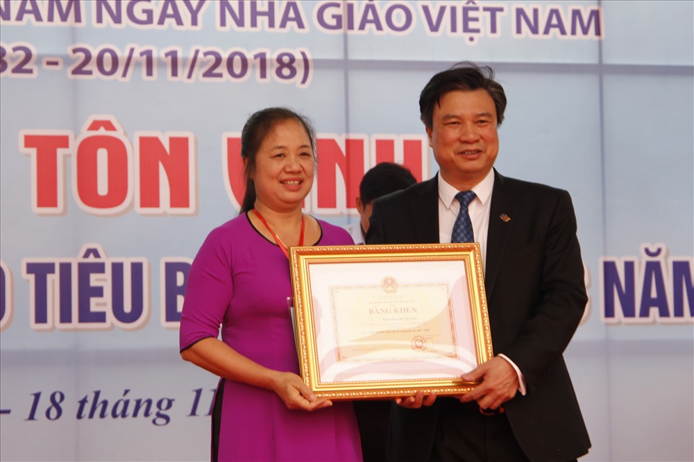 Thứ trưởng Bộ Giáo dục Đào tạo Nguyễn Hữu Độ trao tặng bằng khen cho các thầy cô tiêu biểu. Ảnh: Nguyễn Hà