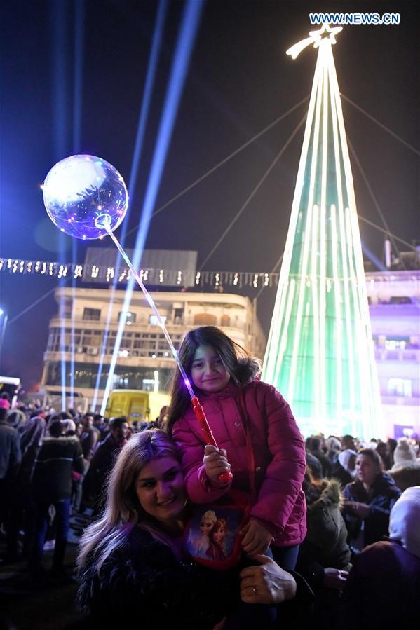 Một cô gái Syria và mẹ cô chụp ảnh trong lễ Giáng sinh ở Damascus, thủ đô của Syria, vào ngày 22 tháng 12 năm 2018. 