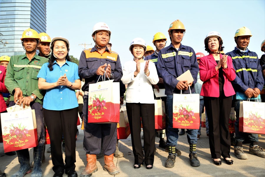 Bà Trương Thị Mai (thứ hai, phải qua) và bà Nguyễn Thị Thu Hồng (thứ hai, trái qua) thăm và chúc tết công nhân tại công trình Metro số 1.