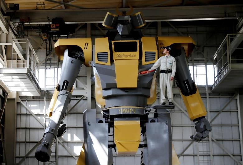 Kỹ sư Go Sakakibara của công ty Sakakibara Kikai đứng bên con robot hình người Mononofu trong cuộc trình diễn robot tại một nhà máy ở tỉnh Gunma, Nhật Bản. Robot LW-Mononofu là sản phẩm của công ty Sakakibara Kikai, nó sở hữu chiều cao 8,5m và nặng hơn 7 tấn. Mononofu chứa một buồng lái, phi công có thể đi vào bằng thang máy để điều khiển tay và chân của robot. (Ảnh: REUTERS)