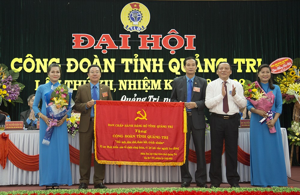 Đông chí Nguyễn Văn Hùng (thứ hai từ phải sang) trao tặng bức trướng cho LĐLĐ Quảng Trị (ảnh: P.V)