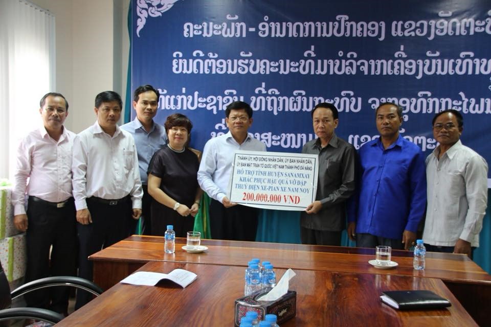 Phó Bí thư thường trực Thành ủy Đà Nẵng Võ Công Trí (thứ 5 từ trái sang) trao cho huyện Sanamxay 200 triệu đồng (Ảnh: T.A) 