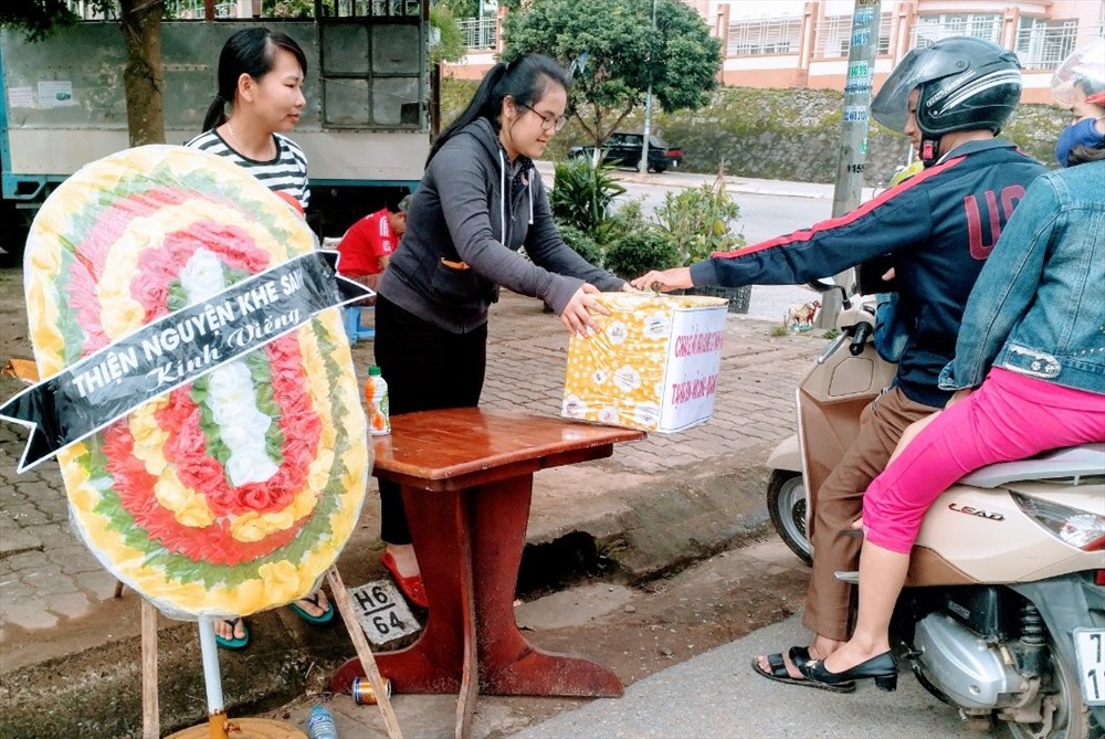 Người dân tham gia giao thông ủng hộ tiền ở thùng từ thiện của nhóm Thiện nguyện Khe Sanh. Ảnh: CT.