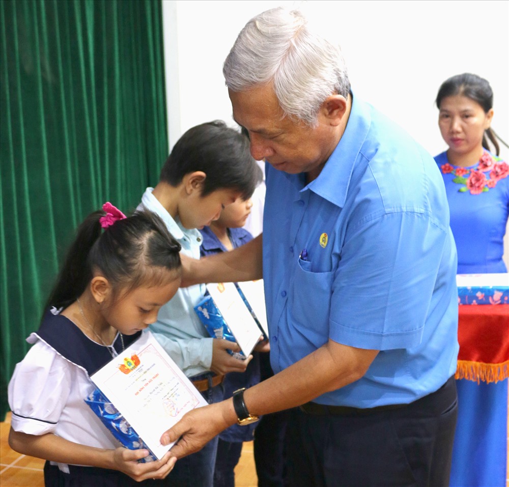 Chủ tịch LĐLĐ An Giang Nguyễn Thiện Phú trao học bổng cho các cháu Tiểu học. Ảnh: Lục Tùng