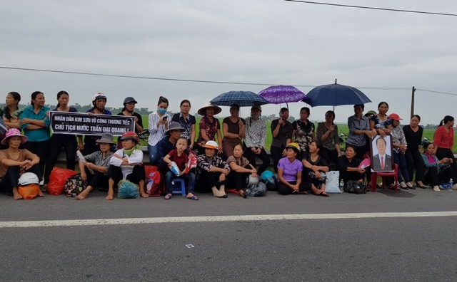 Từ sáng sớm, người dân Kim Sơn đã tập trung dọc hai bên Quốc lộ 10 để đón đoàn xe đưa linh cữu Chủ tịch Nước Trần Đại Quang. Ảnh: NT