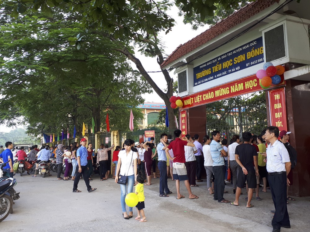 Hàng trăm phụ huynh đứng trước cổng trường theo dõi lễ khai giảng năm học 2018-2019. Ảnh Trần Vương