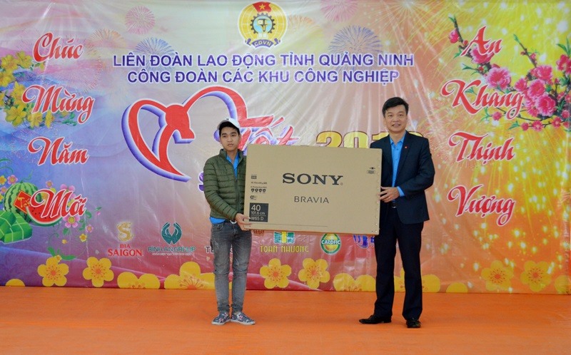 Chủ tịch Công đoàn các KCN tỉnh Quảng Ninh trao ti vi cho người lao động may mắn trúng thưởng. Ảnh: T.N.D