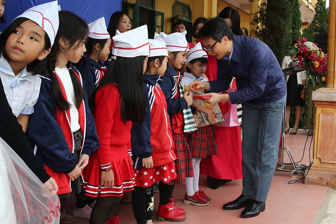 Thủ tướng Vũ Đức Đam tặng sách cho học sinh. Ảnh: VGP/Đình Nam.