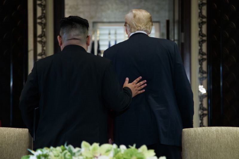 Tổng thống Donald Trump và nhà lãnh đạo Triều Tiên Kim Jong-un rời đi sau lễ ký kết sau cuộc họp tại đảo Sentosa, Singapore. Ảnh: AP.  