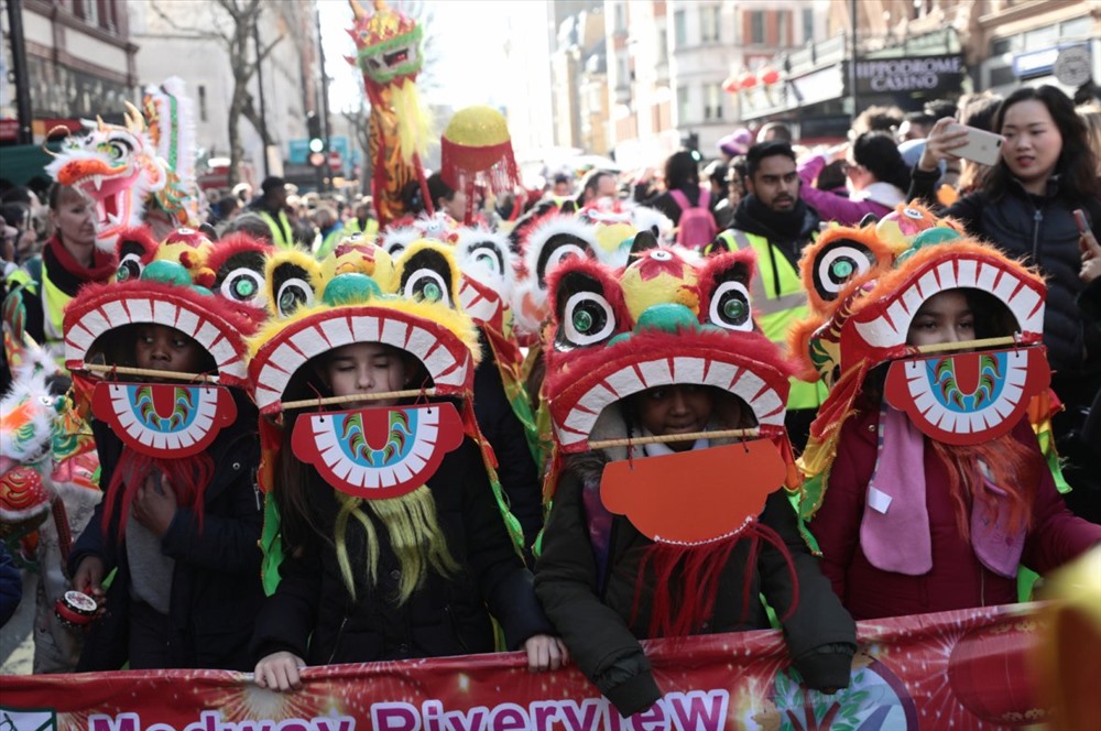 Màn biểu diễn múa lân và khán giả theo dõi trước Phòng trưng bày nghệ thuật ở London, Anh: Ảnh: China Daily. 