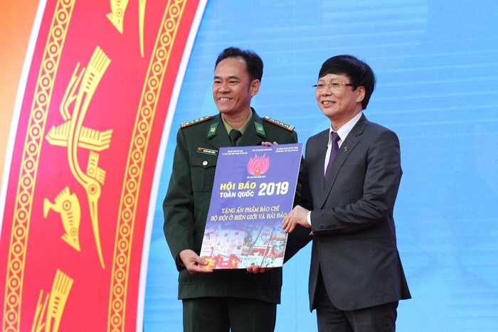 Nhà báo Hồ Quang Lợi - Phó Chủ tịch Thường trực Hội Nhà báo Việt Nam tặng ấn phẩm báo chí cho chiến sĩ bộ đội Hải quân và bộ đội biên phòng.